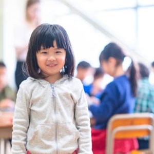A portrait of a cute little girl in classroom.